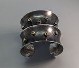 Sterling Silver Wide Anti-Clastic Bracelet with Green  Diamonds in 14kt Gold Bezels